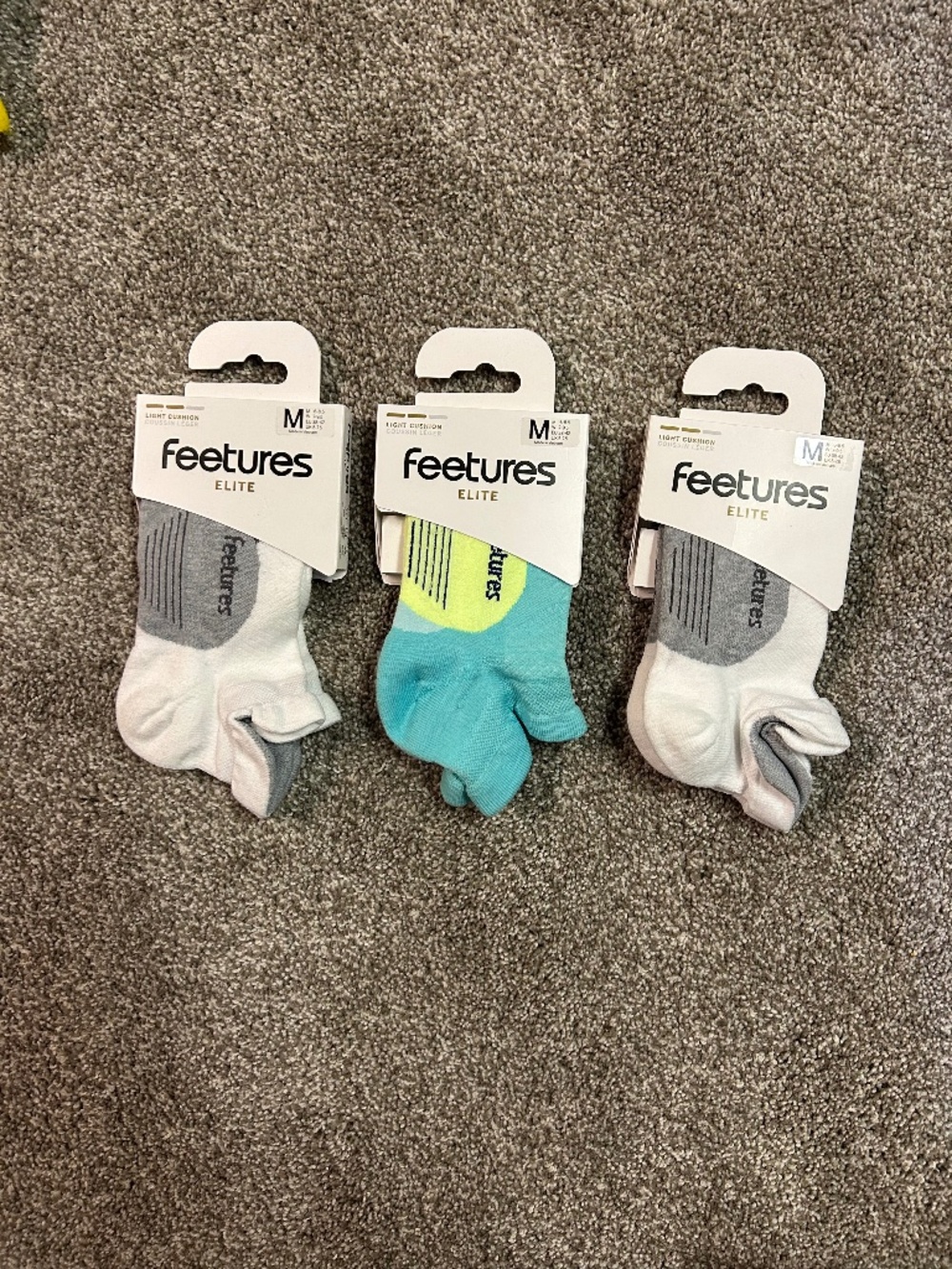 Three pairs Feetures Elite M light cushion socks